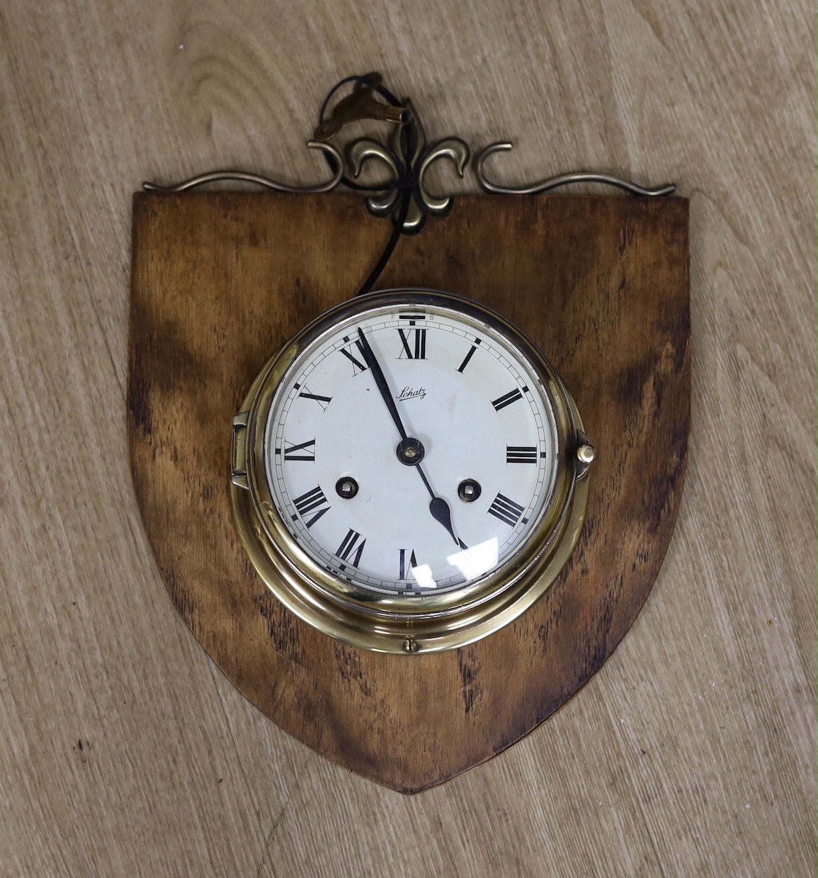 A Schatz brass bulkhead timepiece, mounted